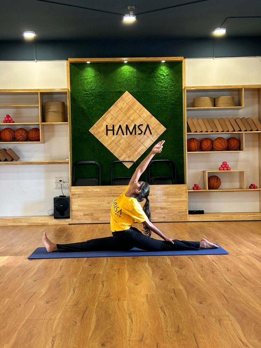 Instructor in an extended side-angle pose at Hamsa studio